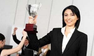 Business woman holding trophy