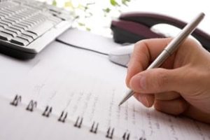 Businessman taking notes and planning in a meeting